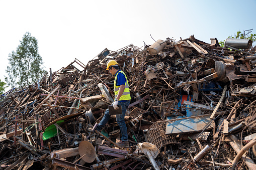 Manager inspects junk pile for removal